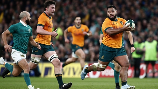 Australia's Taniela Tupou, right, runs with the ball during the Autumn Nations Series rugby union match between Ireland and Australia, at Aviva Stadium, Dublin, Ireland, Saturday, Nov. 30, 2024. (AP Photo/Peter Morrison)