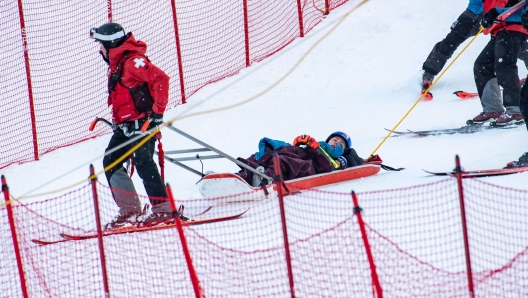 TOPSHOT - Mikaela Shiffrin of team USA is taken away by ski patrol medics in a sled after crashing in the 2024/2025 Women's World Cup Giant Slalom in Killington, Vermont, on November 30, 2024. (Photo by Joseph Prezioso / AFP)