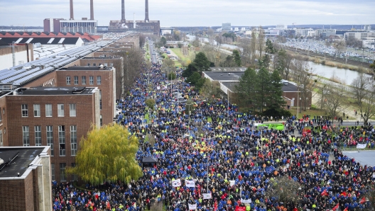 Volkswagen workers attend a rally during at nationwide warning Volkswagen workers' strike, on the grounds of the main Volkswagen plant in Wolfsburg, Germany, Monday, Dec. 2, 2024. (Julian Stratenschulte/Pool Photo via AP)