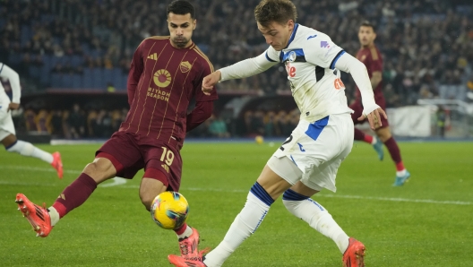 Roma's Zeki Celik, left, and Atalanta's Mateo Retegui vie for the ball during the Italian Series A soccer match between Roma and Atalanta, at Rome's Olympic Stadium, Monday, Dec. 2, 2024. (AP Photo/Gregorio Borgia)