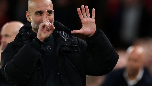 Manchester City's Spanish manager Pep Guardiola reacts to Liverpool fans chanting jeers during the English Premier League football match between Liverpool and Manchester City at Anfield in Liverpool, north west England on December 1, 2024. (Photo by Adrian Dennis / AFP) / RESTRICTED TO EDITORIAL USE. No use with unauthorized audio, video, data, fixture lists, club/league logos or 'live' services. Online in-match use limited to 120 images. An additional 40 images may be used in extra time. No video emulation. Social media in-match use limited to 120 images. An additional 40 images may be used in extra time. No use in betting publications, games or single club/league/player publications. /