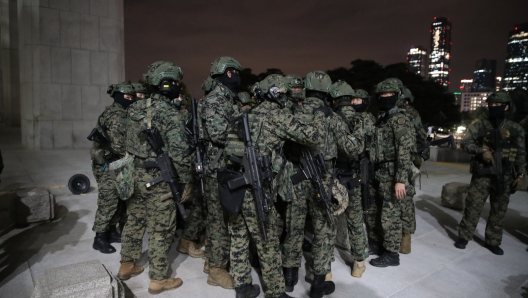 SEOUL, SOUTH KOREA - DECEMBER 03: South Korean soldiers try get into the national assembly on December 03, 2024 in Seoul, South Korea. South Korean lawmakers voted to lift the declaration of emergency martial law announced earlier by President Yoon Suk Yeol in a televised speech. Since taking office two years ago, Mr Yoon has struggled to push his agendas against an opposition-controlled parliament. (Photo by Chung Sung-Jun/Getty Images)