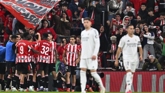 Athletic Bilbao's Alex Berenguer celebrates with teammates after scoring his sides first goal during the Spanish La Liga soccer match between Athletic Bilbao and Real Madrid at the San Mames stadium in Bilbao, Spain, Wednesday, Dec. 4, 2024. (AP Photo/Miguel Oses)