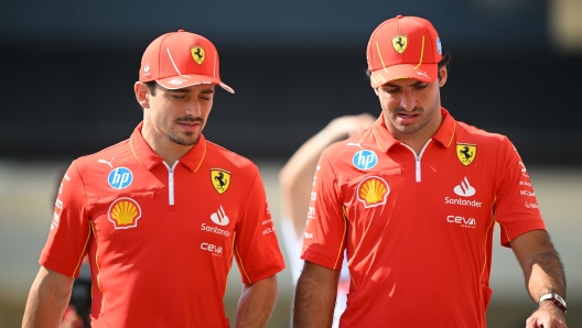 ABU DHABI, UNITED ARAB EMIRATES - DECEMBER 07: Carlos Sainz of Spain and Ferrari and Charles Leclerc of Monaco and Ferrari walk in the Paddock prior to final practice ahead of the F1 Grand Prix of Abu Dhabi at Yas Marina Circuit on December 07, 2024 in Abu Dhabi, United Arab Emirates. (Photo by Clive Mason/Getty Images)