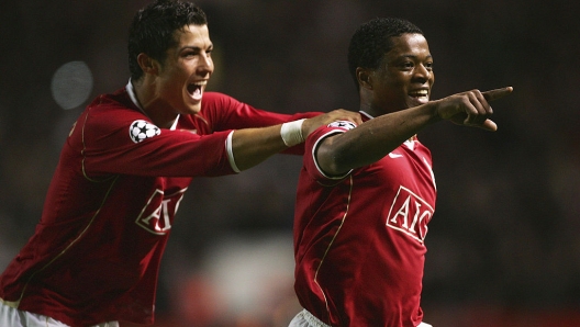 MANCHESTER, UNITED KINGDOM - APRIL 10:  Patrice Evra of Manchester United celebrates scoring his team's seventh goal with team mate Cristiano Ronaldo during the UEFA Champions League Quarter Final, second leg match between Manchester United and AS Roma at Old Trafford on April 10, 2007 in Manchester, England.  (Photo by Alex Livesey/Getty Images) *** Local Caption *** Patrice Evra;Cristiano Ronaldo