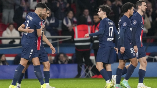 PSG's Goncalo Ramos, left, celebrates with teammates after scoring his side's third goal during the French League One soccer match between Paris Saint-Germain and Lyon at the Parc des Princes in Paris, Sunday, Dec. 15, 2024. (AP Photo/Aurelien Morissard)