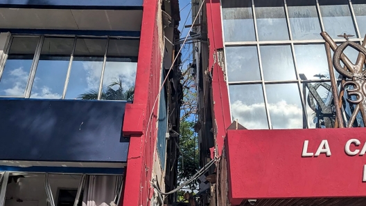 This photo shows a general view of a severely damaged building housing the embassies of the United States, United Kingdom, and New Zealand after a powerful earthquake struck Port Vila, the capital city of Vanuatu, on December 17, 2024. A powerful earthquake hit the Pacific island of Vanuatu on December 17, smashing buildings in the capital Port Vila including one housing the US and other embassies, with a witness telling AFP of bodies seen in the city. (Photo by AFP)