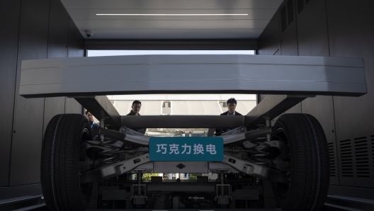 Attendees look at the next generation battery swapping station by China-based CATL battery manufacturing company, before a launch presentation in Xiamen in Xiamen, Fujian province, China, Wednesday, Dec. 18, 2024. (AP Photo/Ng Han Guan)