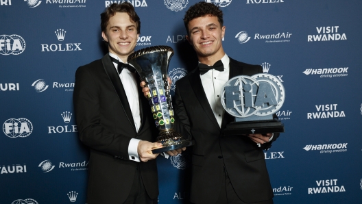 KIGALI, RWANDA - DECEMBER 13: In this handout provided by Federation Internationale de l'Automobile (FIA), Lando Norris of Great Britain and Mclaren and and Oscar Piastri of Australia and Mclaren pose for a photograph with the Constructors Championship award during the FIA Awards 2024 on December 13, 2024 in Kigali, Rwanda.  (Photo by Handout/FIA/DPPI via Getty Images )