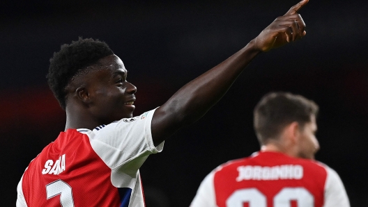 Arsenal's English midfielder #07 Bukayo Saka celebrates scoring the team's second goal during the UEFA Champions League football match between Arsenal and Monaco at the Emirates Stadium in north London, on December 11, 2024. (Photo by Glyn KIRK / AFP)