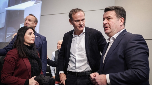 TOPSHOT - (L to R) The chairwoman of the General and Group Works Council of the Volkswagen Group Daniela Cavallo, Volkswagen (VW) CEO Oliver Blume and German Minister of Labour and Social Affairs Hubertus Heil greet each prior to a company wide meeting at the company's headquarters plant in Wolfsburg, central Germany, on December 4, 2024. Volkswagen workers all over Germany are in an escalating industrial dispute at the crisis-hit German auto giant with thousands of jobs at stake. Labour representatives say VW wants to close at least three plants in Germany and axe tens of thousands of jobs, with remaining workers facing 10 percent pay cuts. (Photo by Ronny HARTMANN / POOL / AFP)