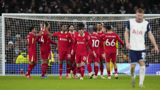 Liverpool players celebrate after teammate Mohamed Salah scored his side's fourth goal during the English Premier League soccer match between Tottenham and Liverpool at Tottenham Hotspur Stadium in London, Sunday, Dec. 22, 2024. (AP Photo/Dave Shopland)