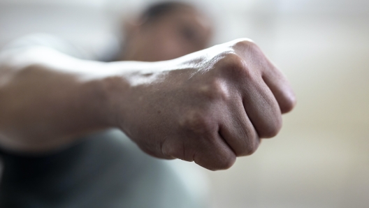 The angry man clenched his fist. Concept of violence.