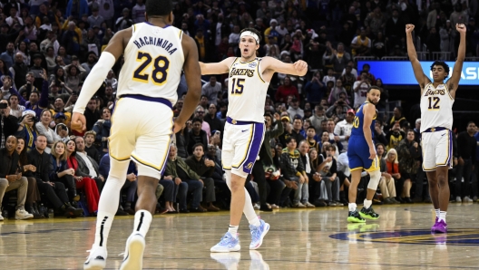 Los Angeles Lakers guard Austin Reaves (15), forward Rui Hachimura (28), and guard Max Christie (12) celebrate their win over the Golden State Warriors after an NBA basketball game, Wednesday, Dec. 25, 2024, in San Francisco. (AP Photo/Eakin Howard)