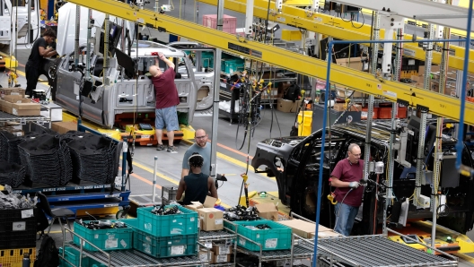 (FILES) Ford Motor Co. battery powered F-150 Lightning trucks under production at their Rouge Electric Vehicle Center in Dearborn, Michigan on September 20, 2022. China's retaliatory export controls could take a toll on the growing US clean energy sector and its defense industry, analysts say, as a trade tussle escalates between the world's two biggest economies. Beijing announced this week it would ban exports of gallium, germanium and antimony to the US, targeting materials used for everything from semiconductors to solar cells. China also tightened restrictions on graphite, which is key to the electric vehicle industry. (Photo by JEFF KOWALSKY / AFP)