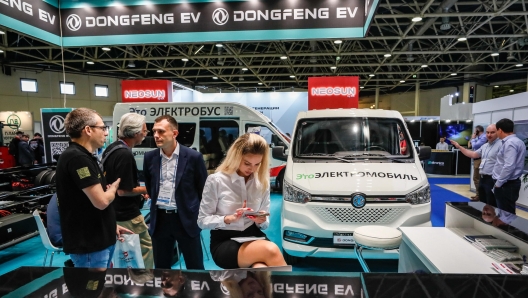 epa11419633 Visitors and participants visit a stand of Chinese company Dongfeng EV during the international exhibition of energy saving, green energy and electric transport RENWEX 2024 in Moscow, Russia 18 June 2024. The exhibition will last from 18 to 20 June 2024.  EPA/YURI KOCHETKOV