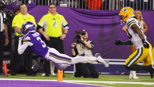 Minnesota Vikings' Jordan Addison catches a touchdown pass in front of Green Bay Packers' Javon Bullard during the second half of an NFL football game Sunday, Dec. 29, 2024, in Minneapolis. (AP Photo/Bruce Kluckhohn)