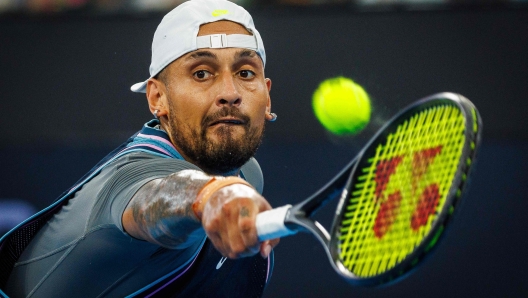 Australias Nick Kyrgios hits a return against Frances Giovanni Rerricard during their mens singles match at the Brisbane International tennis tournament in Brisbane on December 31, 2024. (Photo by Patrick HAMILTON / AFP) / -- IMAGE RESTRICTED TO EDITORIAL USE - STRICTLY NO COMMERCIAL USE --