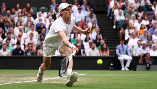 Italy's Jannik Sinner returns against Russia's Daniil Medvedev during their men's singles quarter-final tennis match on the ninth day of the 2024 Wimbledon Championships at The All England Lawn Tennis and Croquet Club in Wimbledon, southwest London, on July 9, 2024. (Photo by HENRY NICHOLLS / AFP) / RESTRICTED TO EDITORIAL USE