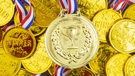 Large gold gold medal on golden medals background