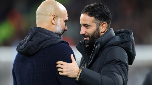 MANCHESTER, ENGLAND - DECEMBER 15: Pep Guardiola, Manager of Manchester City, and Ruben Amorim, Manager of Manchester United, interact prior to the Premier League match between Manchester City FC and Manchester United FC at Etihad Stadium on December 15, 2024 in Manchester, England. (Photo by Carl Recine/Getty Images)