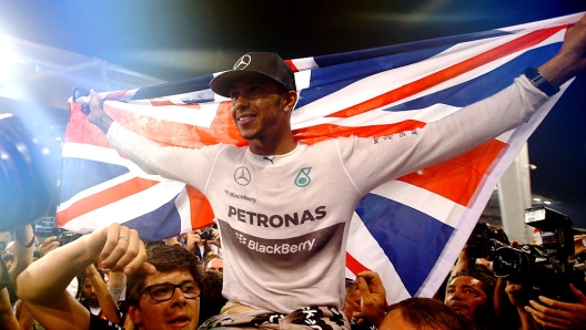 ABU DHABI, UNITED ARAB EMIRATES - NOVEMBER 23:  Lewis Hamilton of Great Britain and Mercedes GP celebrates with his team after winning the World Championship after the Abu Dhabi Formula One Grand Prix at Yas Marina Circuit on November 23, 2014 in Abu Dhabi, United Arab Emirates.  (Photo by Clive Rose/Getty Images)