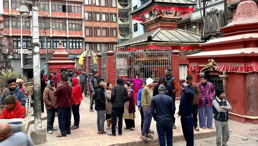 People gather in an open area following earthquake tremors in Kathmandu, in the early hours on January 7, 2025. A powerful earthquake in China's remote Tibet region killed at least 32 people and collapsed "many buildings" on January 7, Chinese media reported, with tremors also felt in neighbouring Nepal's capital Kathmandu and parts of India. (Photo by SUNIL SHARMA / AFP)