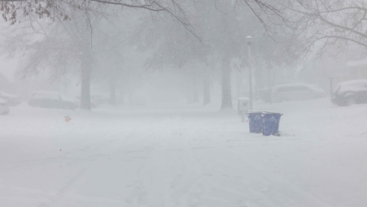 SHAWNEE, KANSAS - JANUARY 5: Dense snow fall and wind reduce visibility on January 5, 2025 in Shawnee, Kansas. Conditions have worsened since the morning hours making it difficult to be outside or drive. Snow drifts have grown and the sidewalks are difficult to walk on in the deep snow. A large swath of the U.S., across the Midwest to the East Coast is experiencing a major Winter storm, with more than two feet of snow in some areas. A state of emergency has been declared in Kentucky and Virginia.   Chase Castor/Getty Images/AFP (Photo by Chase Castor / GETTY IMAGES NORTH AMERICA / Getty Images via AFP)