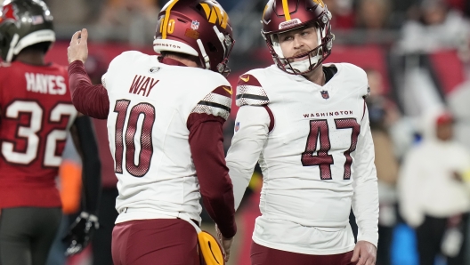 Washington Commanders place kicker Zane Gonzalez (47) is congratulated by Tress Way (10) after kicking a field goal during the second half of an NFL wild-card playoff football game against the Tampa Bay Buccaneers in Tampa, Fla., Sunday, Jan. 12, 2025. (AP Photo/Chris O'Meara)