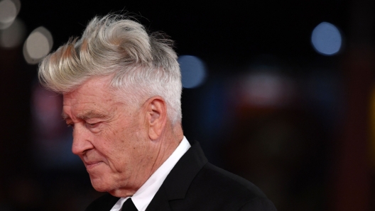 (FILES) US director David Lynch arrives to the 12th Rome Film Festival on November 4, 2017 in Rome. Hollywood film director David Lynch disclosed August 5, he was living with emphysema, a chronic lung disease, but it has not forced him into retirement. "Yes, I have emphysema from my many years of smoking," Lynch wrote on X, formerly Twitter.  Lynch, 78, had originally discussed the diagnosis in an interview published in the British film magazine Sight and Sound, where he said the condition affected his mobility and that he was only able to continue directing remotely, according to multiple media reports. (Photo by TIZIANA FABI / AFP)