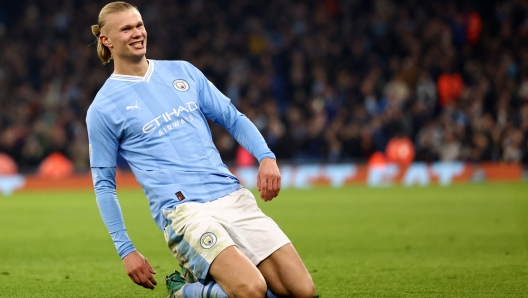 (FILES) Manchester City's Norwegian striker #09 Erling Haaland celebrates scoring his team's third goal during the UEFA Champions League Group B second leg football match between Manchester City and Young Boys at the Etihad Stadium in Manchester, north west England, on November 7, 2023. Erling Haaland has signed a 10-year contract that will keep him at the Etihad Stadium until 2034, the club announced Friday January 17. (Photo by Darren Staples / AFP)