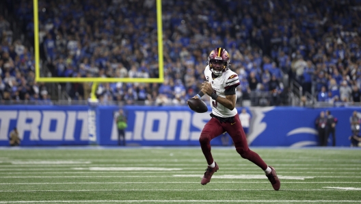 Washington Commanders quarterback Jayden Daniels (5) runs the ball against the Detroit Lions during the second half of an NFL football divisional playoff game, Saturday, Jan. 18, 2025, in Detroit. (AP Photo/Mike Mulholland)