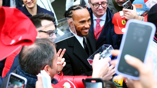 FIORANO MODENESE, ITALY - JANUARY 20: Sir Lewis Hamilton greets fans during his first official days as a Scuderia Ferrari F1 driver at Fiorano Circuit on January 20, 2025 in Fiorano Modenese, Italy. (Photo by Clive Rose/Getty Images)