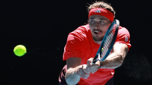 MELBOURNE, AUSTRALIA - JANUARY 24: Alexander Zverev of Germany plays a backhand against Novak Djokovic of Serbia in the Men's Singles Semifinal during day 13 of the 2025 Australian Open at Melbourne Park on January 24, 2025 in Melbourne, Australia. (Photo by Darrian Traynor/Getty Images)