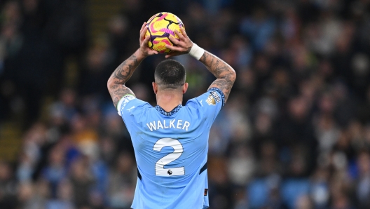 MANCHESTER, ENGLAND - DECEMBER 15: Kyle Walker of Manchester City takes a throw in during the Premier League match between Manchester City FC and Manchester United FC at Etihad Stadium on December 15, 2024 in Manchester, England. (Photo by Michael Regan/Getty Images)