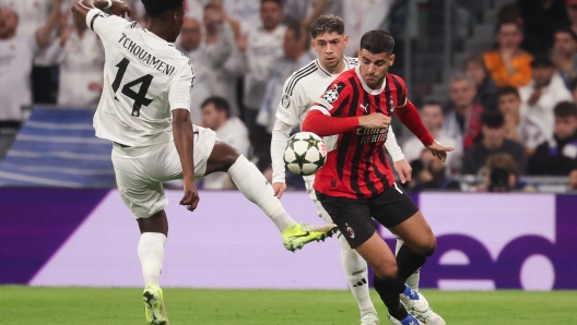 Real Madrid's French midfielder #14 Aurelien Tchouameni (L) is challenged by AC Milan's Spanish forward #07 Alvaro Morata during the UEFA Champions League, league phase day 4 football match between Real Madrid CF and AC Milan at the Santiago Bernabeu stadium in Madrid on November 5, 2024. (Photo by Pierre-Philippe MARCOU / AFP)