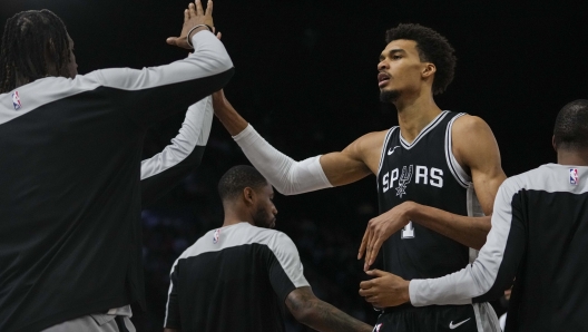 San Antonio Spurs center Victor Wembanyama (1) celebrates as he comes off the court during the first half of a Paris Games 2025 NBA basketball game against the Indiana Pacers in Paris, Saturday, Jan. 25, 2025. (AP Photo/Thibault Camus)