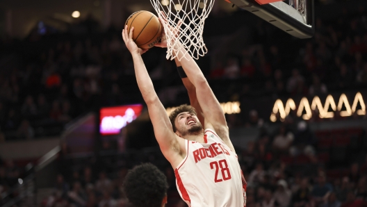 Houston Rockets center Alperen Sengun (28) grabs a rebound during an NBA basketball game against the Portland Trail Blazers Saturday, Jan. 18, 2025, in Portland, Ore. The Houston Rockets won 125-103. (AP Photo/Amanda Loman)