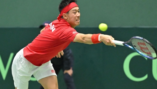 Japan's Kei Nishikori returns a shot against Britain's Jacob Fearnley during their men's singles match of the Davis Cup team tennis qualifiers at Bourbon Beans Dome in Miki, Hyogo Prefecture on January 31, 2025. (Photo by JIJI Press / AFP) / Japan OUT