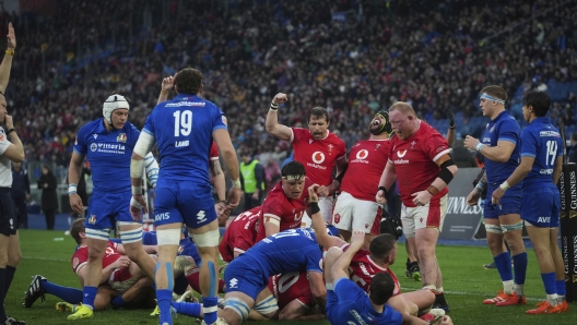 Wales' players celebrate after Wale's Aaron Wainwright, unseen, scored a try during the Six Nations rugby union match between Italy and Wales at the Olympic Stadium in Roma, Italy, Saturday, Feb. 8, 2025. (AP Photo/Alessandra Tarantino)