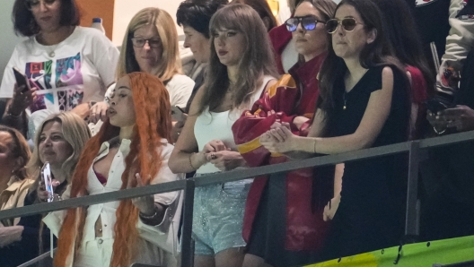 Ice Spice, from left, Taylor Swift, Este Haim and Alana Haim watch during the first half of the NFL Super Bowl 59 football game between the Kansas City Chiefs and the Philadelphia Eagles, Sunday, Feb. 9, 2025, in New Orleans. (AP Photo/Gerald Herbert)