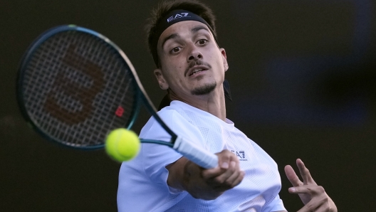 Lorenzo Sonego of Italy plays a forehand return to Ben Shelton of the U.S. during their quarterfinal match at the Australian Open tennis championship in Melbourne, Australia, Wednesday, Jan. 22, 2025. (AP Photo/Ng Han Guan)