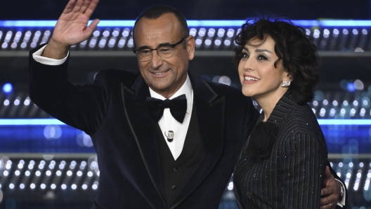 Sanremo Festival host and artistic director Carlo Conti and his wife Francesca Vaccaro on stage of the Ariston theatre during the 75th edition of the Sanremo Italian Song Festival, in Sanremo, Italy, 11 February 2025. The music festival will run from 11 to 15 February 2025. ANSA/ETTORE FERRARI