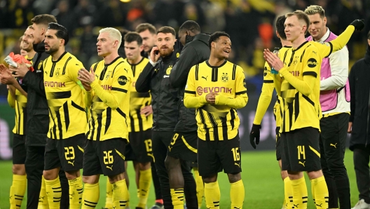 Dortmund's players celebrate with their fans after the UEFA Champions League - Knockout round play-off Second Leg match Borussia Dortmund v Sporting CP at the Signal Iduna stadium in Dortmund, western Germany, on February 19, 2025. (Photo by INA FASSBENDER / AFP)