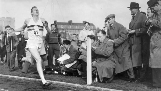 Roger Bannister about to cross the tape at the end of his record breaking mile run at Iffley Road, Oxford. He was the first person to run the mile in under four minutes, with a time of 3 minutes 59.4 seconds.  (Photo by Norman Potter/Central Press/Hulton Archive/Getty Images)