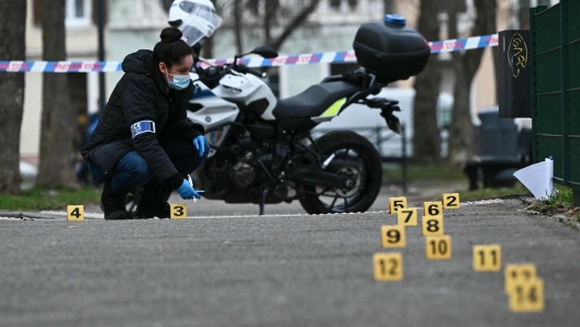 A police investigator of the French forensic police works to collect evidence at the site of a bladed weapon attack where a man is suspected of killing one person and wounding two municipal police officers in Mulhouse, eastern France on February 22, 2025. (Photo by SEBASTIEN BOZON / AFP)