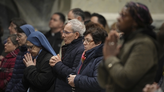 Faithful and nuns gather at St. John Lateran Basilica in Rome Sunday, Feb. 23, 2025, to pray for Pope Francis who was admitted over a week ago at Rome's Agostino Gemelli Polyclinic and is in critical condition. (AP Photo/Alessandra Tarantino)