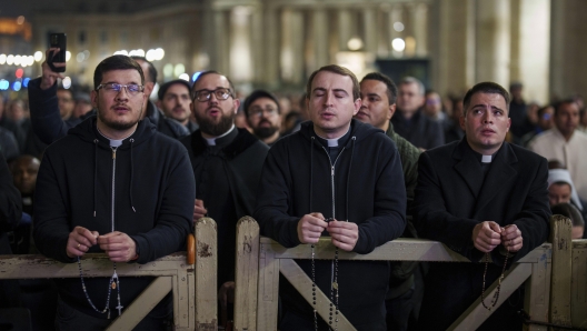 Catholic priests pray the rosary in St. Peter's Square at The Vatican for the recovery of Pope Francis, Monday, Feb. 24, 2025. (AP Photo/Bernat Armangue)  Associated Press/LaPresse