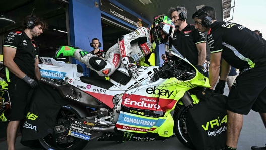 Pertamina Enduro VR46 Racing Team's Italian rider Franco Morbidelli gets on his bike next to the garage during the free practice 1 session of the MotoGP Thailand Grand Prix at the Buriram International Circuit in Buriram on February 28, 2025. (Photo by Lillian SUWANRUMPHA / AFP)