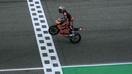 Red Bull KTM Ajo's Soanish rider Jose Antonio Rueda celebrates as he crosses the finish line to win the Moto3 race at the MotoGP Thailand Grand Prix at the Buriram International Circuit in Buriram on March 2, 2025. (Photo by Lillian SUWANRUMPHA / AFP)